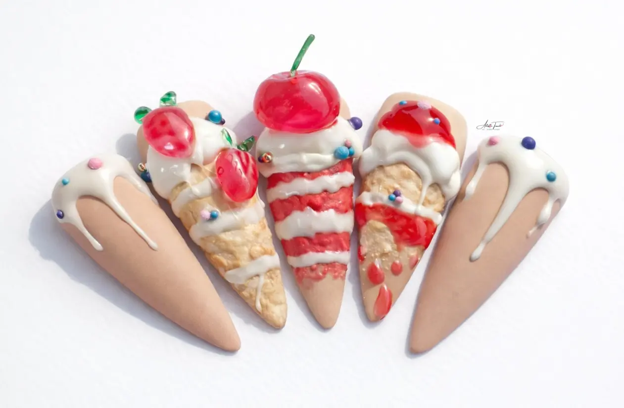 Close-up detail of 3D cake nail art showing dripping frosting technique and dimensional fruit decoration with realistic colour gradients
