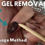 Proper technique for gently scraping softened gel polish with orange wood stick showing crumbly texture indicating correct soaking time