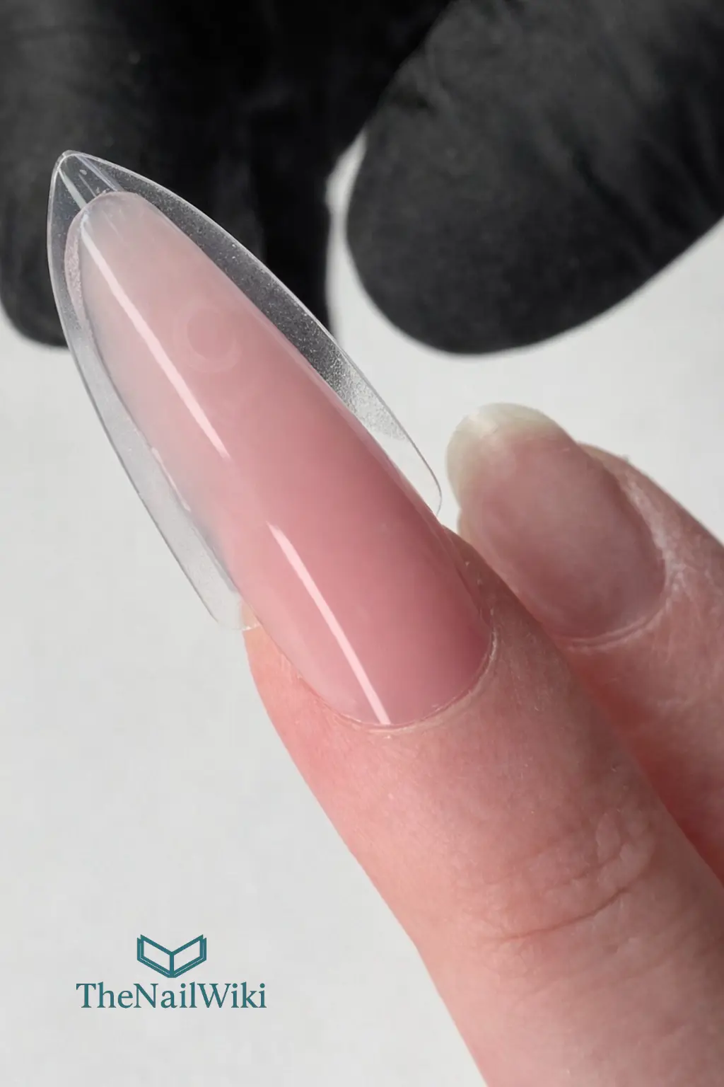 Product placed inside a Sandwich dual form just before pressing onto the nail — showing correct placement with the thickest concentration at the stress zone